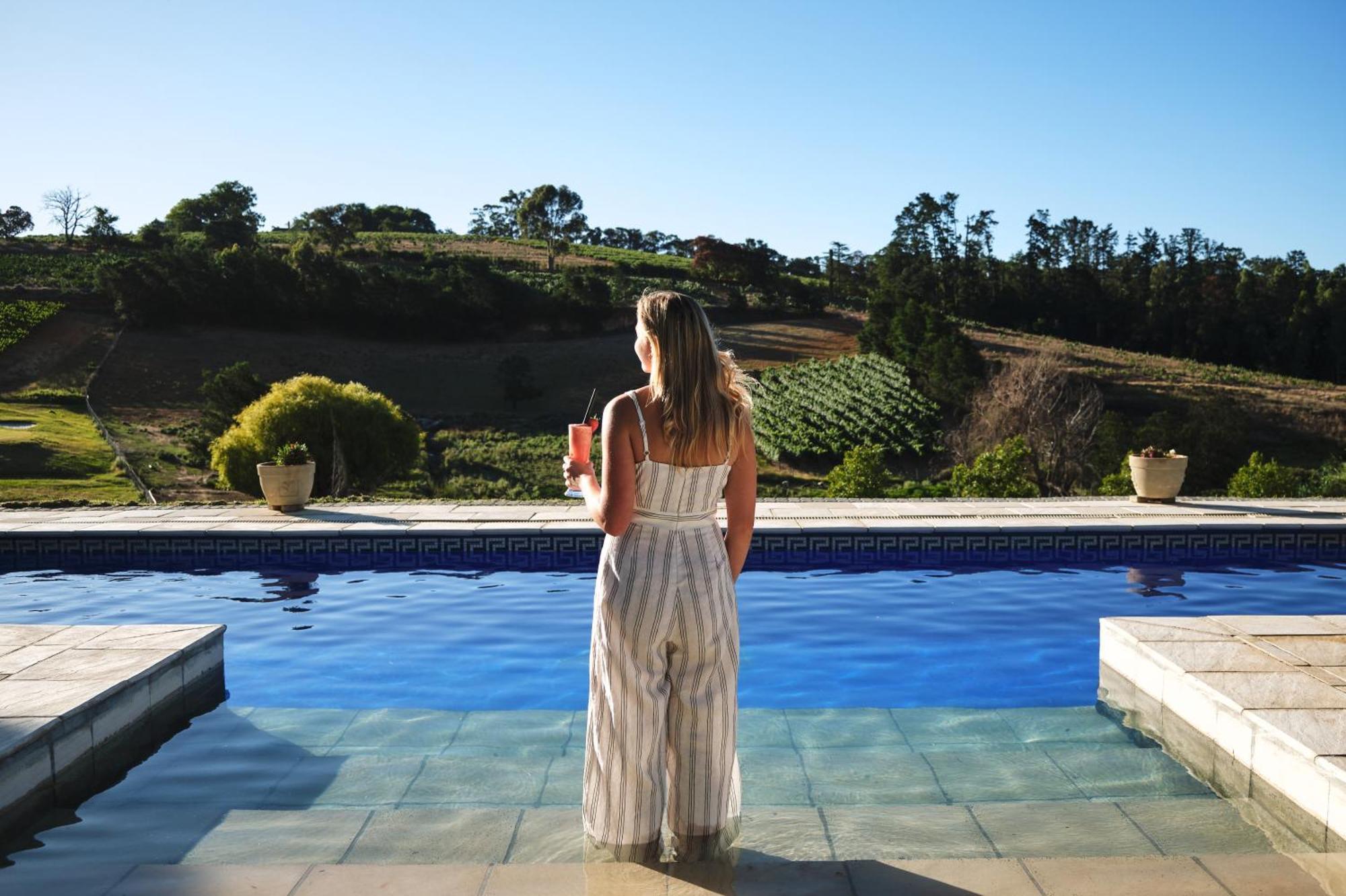 Alluvia Boutique Winery & Luxury Accommodation Stellenbosch Room photo A woman standing by a pool
