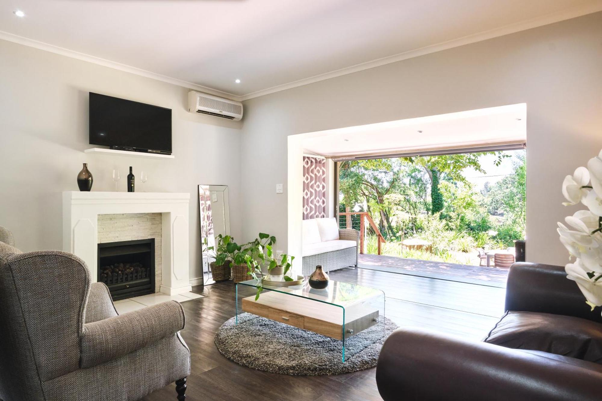 Alluvia Boutique Winery & Luxury Accommodation Stellenbosch Room photo A living room with a fireplace